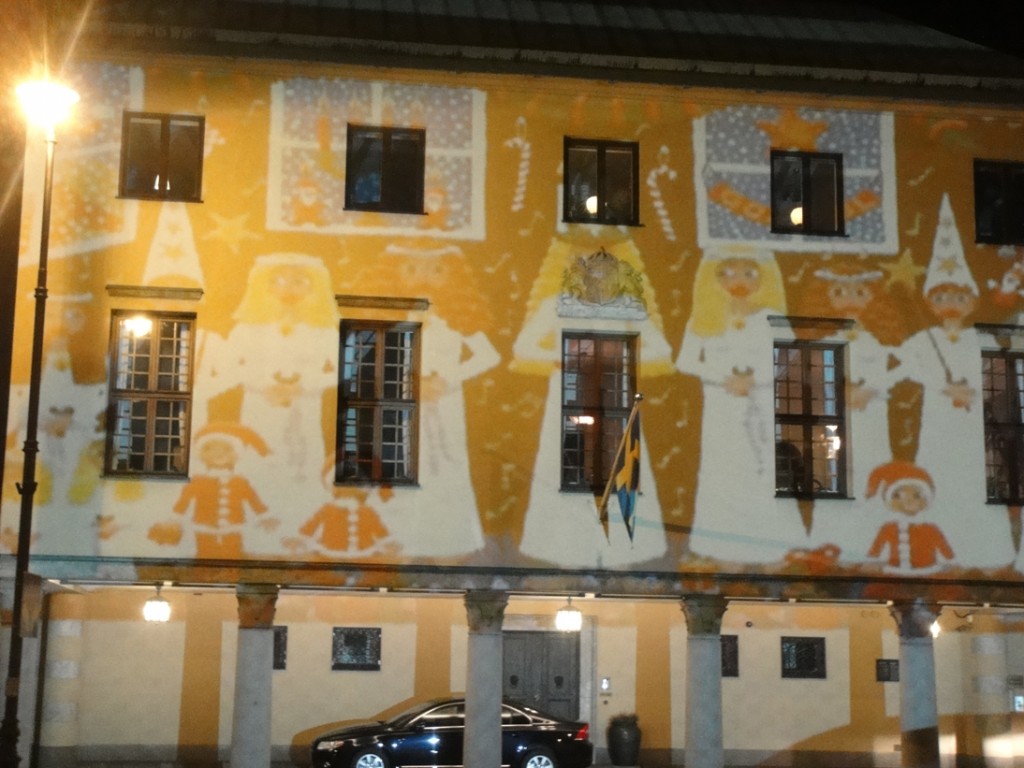 Swedish Lucia animation on Swedish Embassy in Warsaw shown by Projection mapping painting of Swedish St Lucia procession shown on building facade in Warsaw through projection mapping or video mapping