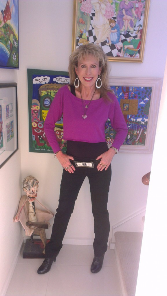 artist marie jonsson harrison with one of her paintings and another by outsider artist Jungle as well as a sculpture by Ted Jonsson