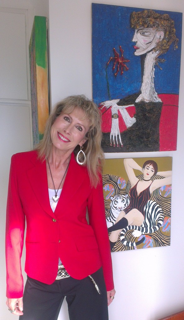 artist marie jonsson harrison dressed in red with artworks by her father ted jonsson and bronwen roodenrys on her way to carols by candlelight