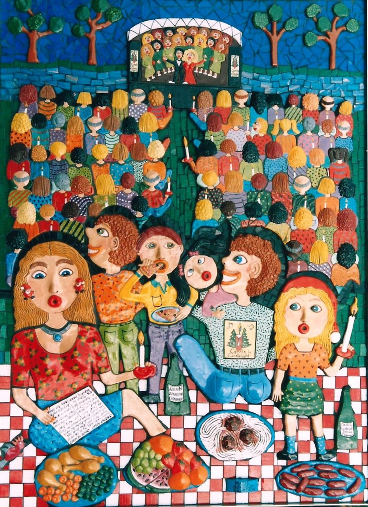 a family sitting on a picnic blanket singing carols by candlelight with the audience in mosaic and ceramic